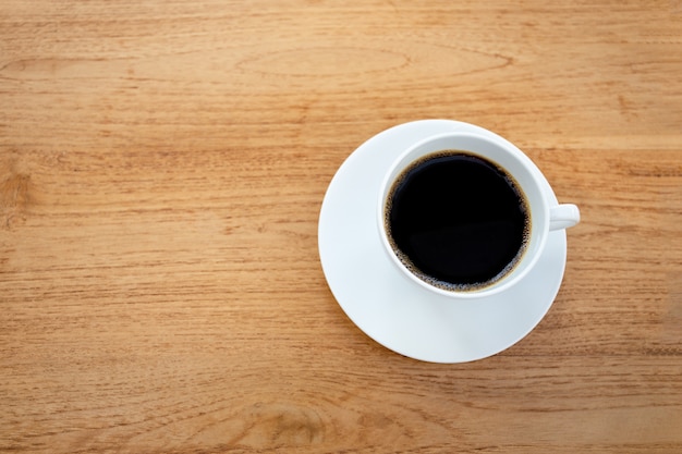 cup of coffee on wooden table.