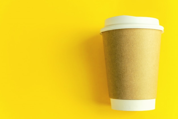 Cup coffee on yellow paper background