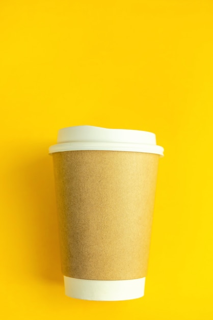 Cup coffee on yellow paper wall. Minimal-concept.