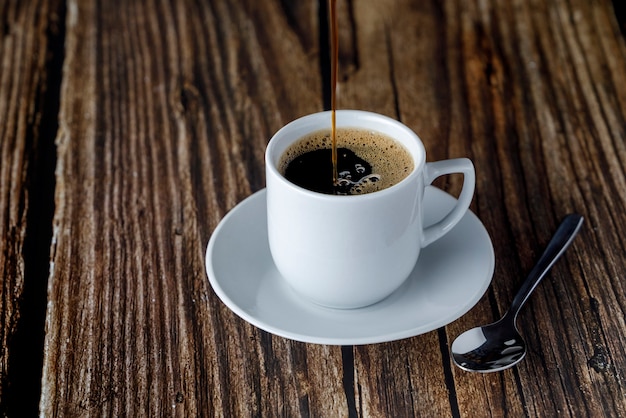 Cup of espresso coffee on wooden table