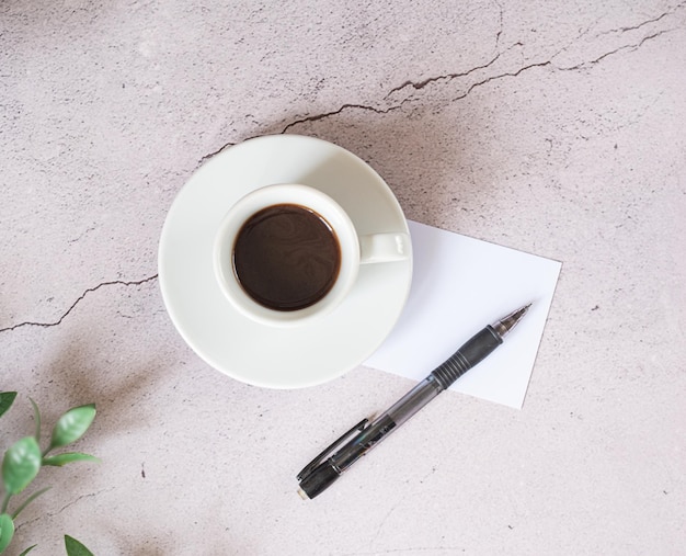 Cup of espresso Cup of coffee with a paper Symbolic image Rustick wooden background Top view