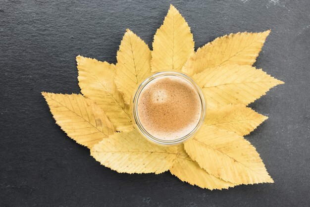 Cup of espresso and and yellow fall leaves