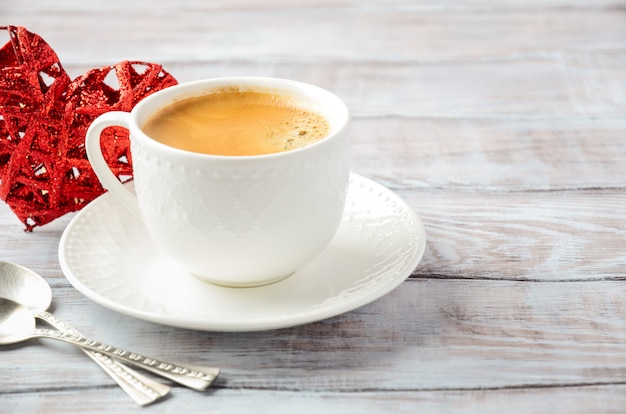 Cup of fresh morning coffee on a wooden table