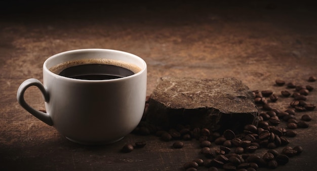 Cup of freshly brewed roasted coffee beans on brown background