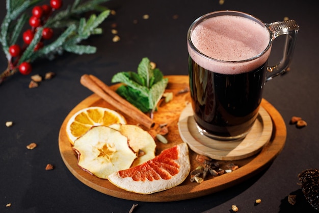 Cup of glintwein with a cinnamon stick and dried exotic fruits, winter hot  drinks