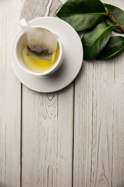 Cup of herbal tea on table