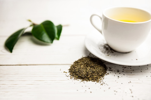 Cup of herbal tea on table