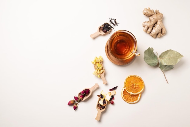 A cup of herbal tea with ginger dried flowers fruits and berries The concept of healthy eating Top view and copy space