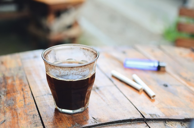 Cup of hot black Americano coffee on wooden table