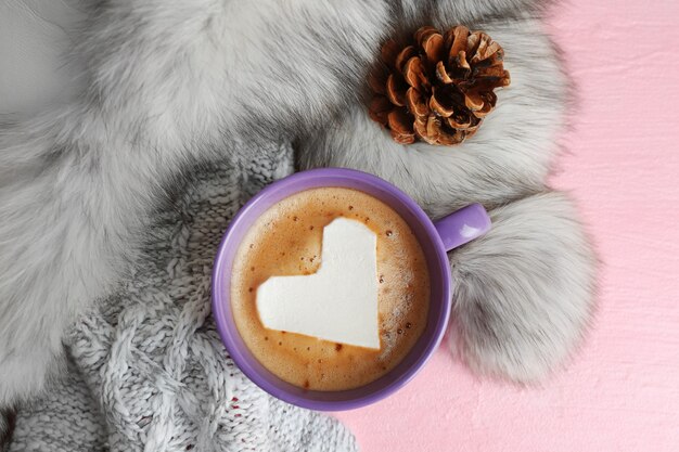 Cup of hot cappuccino with heart marshmallow and fur