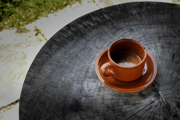 cup of hot chocolate coffee in cup on black wooden table taken from top view