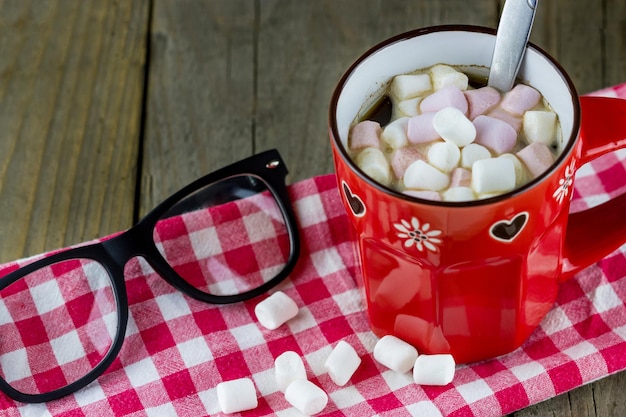 Cup of hot chocolate with marshmallows and glasses 