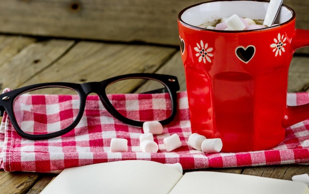 Cup of hot chocolate with marshmallows on the table