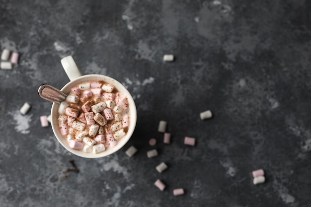 cup of hot cocoa drink with cinnamon sticks, and marshmallow