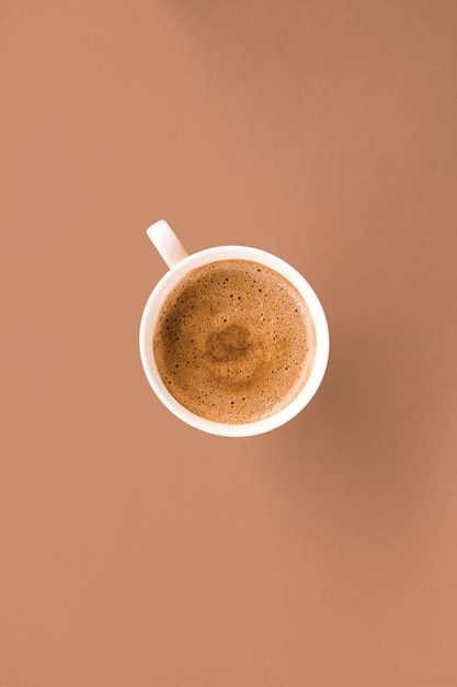 Cup of hot coffee as breakfast drink flatlay cups on beige background