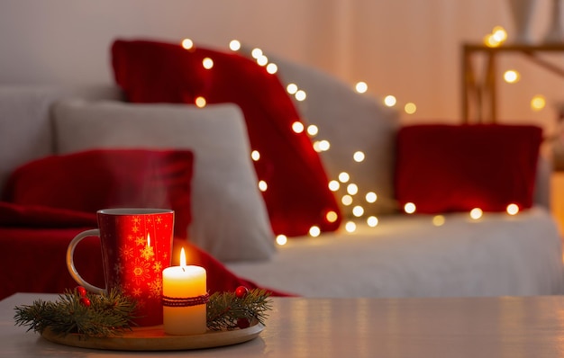 cup of hot drink with christmas decorations in white and red colors at home