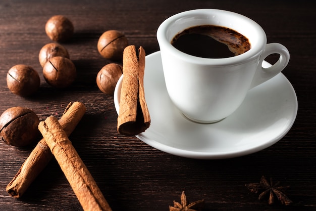 Cup of hot espresso coffee with cinnamon sticks