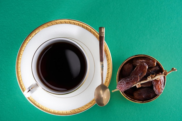 Cup of hot tea and date dry fruit