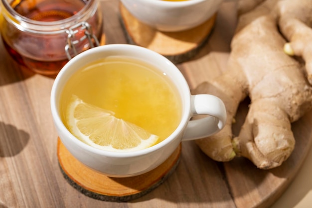 Cup of hot tea with ginger honey and lemon close up