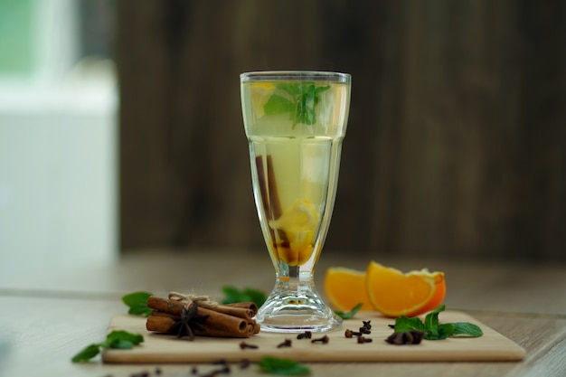 Cup of hot vitamin tea on wooden table. winter hot seasonal drinks