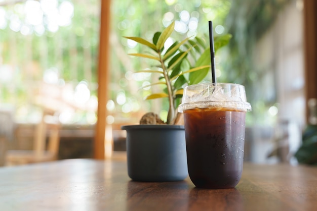 Cup of iced milk coffee with plastic straw