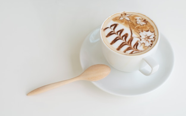 a cup of latte art on white background