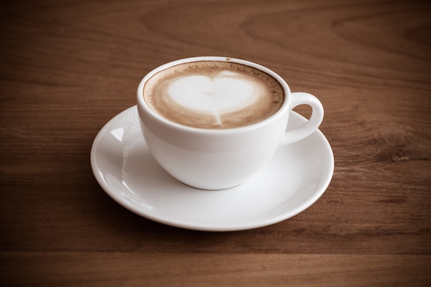 cup of latte coffee on wood table