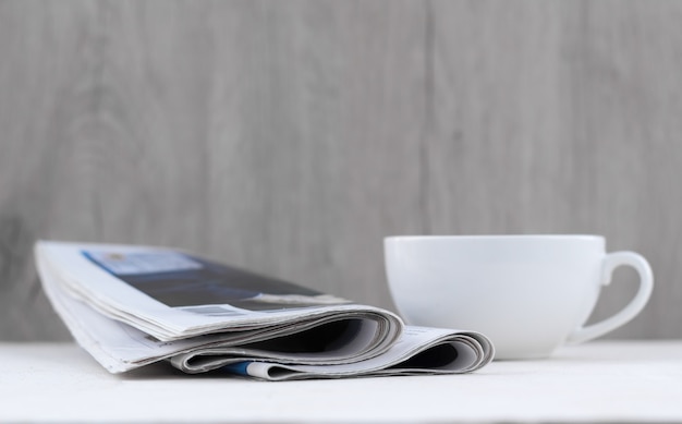 Cup , lavender bouquet, fresh newspaper on table. coffee break