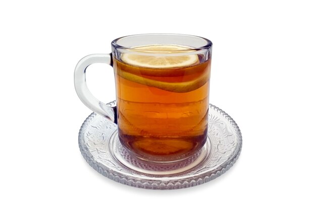 Photo a cup of lemon tea in transparent glass and saucer isolated on white background with clipping path