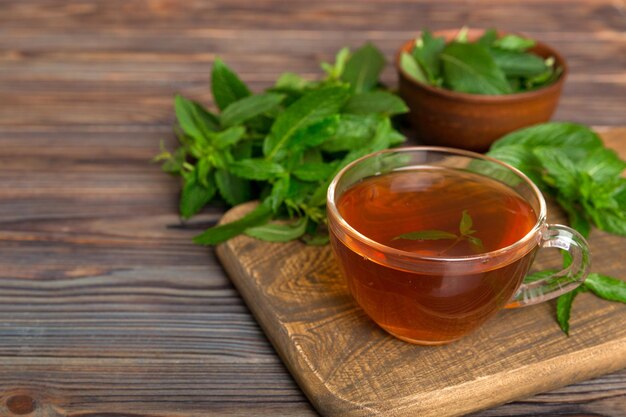 Cup of mint tea on table background Green tea with fresh mint top view with copy space