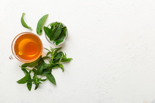 Cup of mint tea on table background Green tea with fresh mint top view with copy space