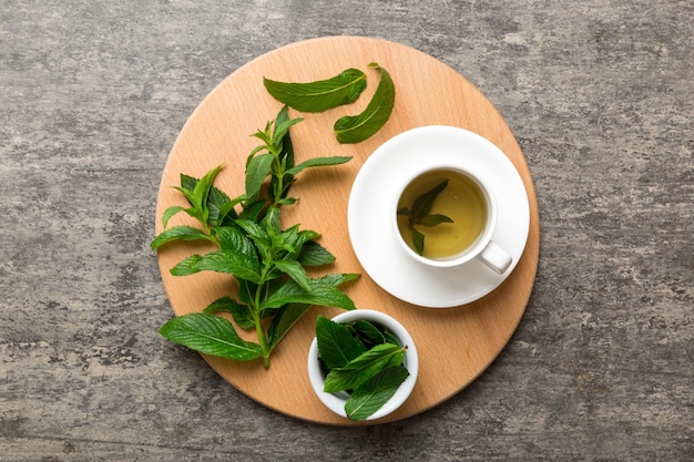 Cup of mint tea on table background Green tea with fresh mint top view with copy space