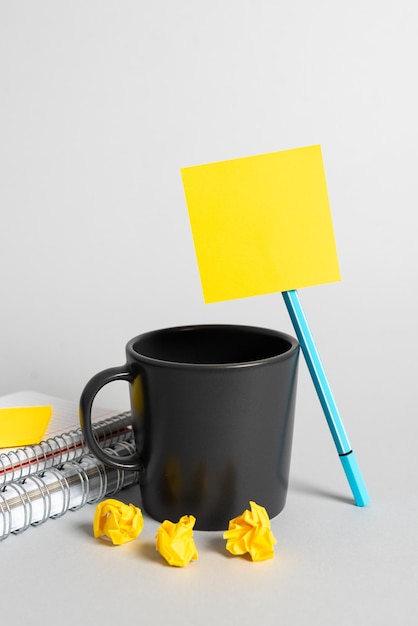 Cup Pen Notebooks Paper Wraps And Sticky Note With Important Message On Desk Mug Pencil Books And Crutial Announcement On Table Coffee Ball Point And Critical Data