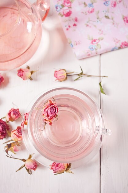 Cup of roses tea on a wooden table