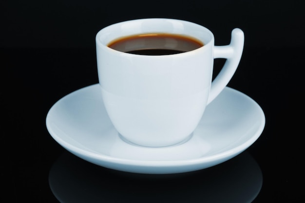 Cup of strong coffee isolated on black