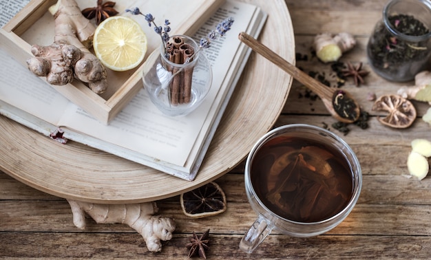 cup of tea and aromatic elements on wooden table