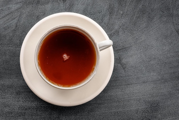 A cup of tea on a black background top view