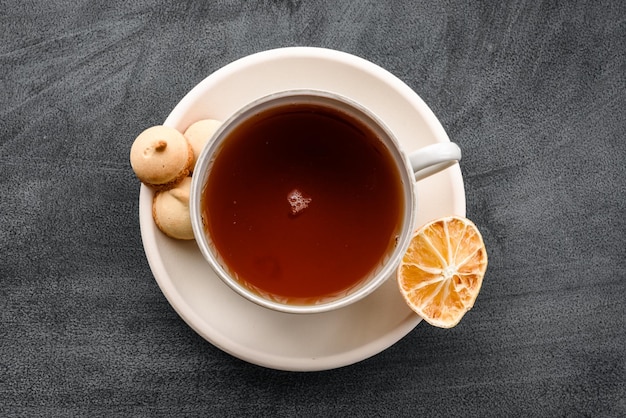 A cup of tea on a black background top view