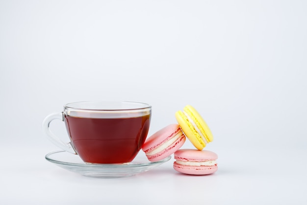 Cup of tea and colorful macaroons isolated