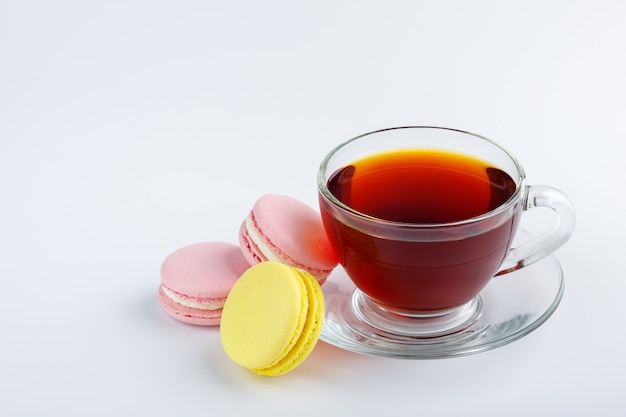 Cup of tea and colorful macaroons isolated