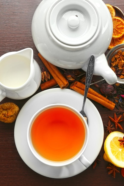 Cup of tea and delicious ingredients on table