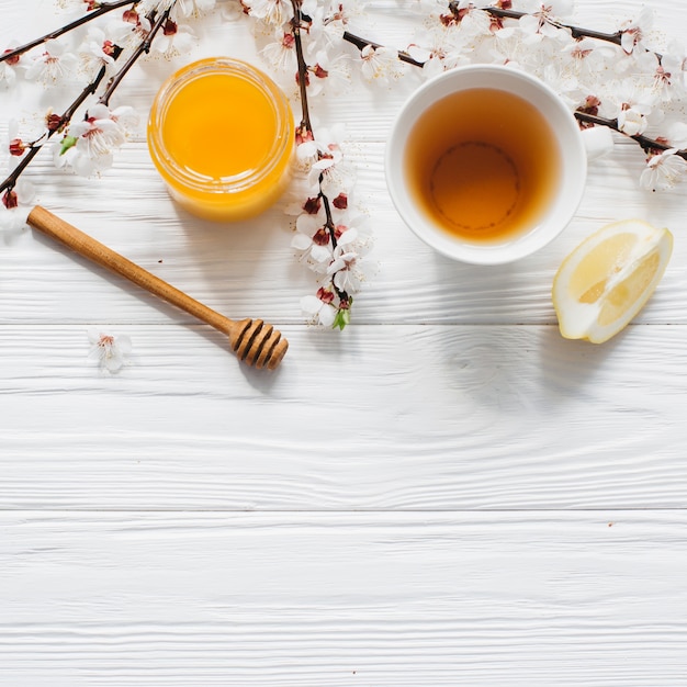 cup of tea and honey on wooden background