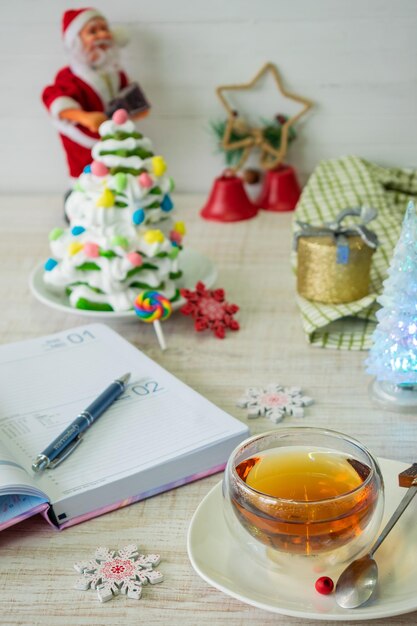 Cup of tea and new year cake weekly planner on the table