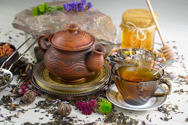 A cup of tea sits next to a cup of tea.