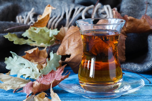 Cup of tea with autumn leaves