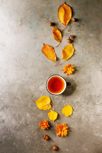 Cup of tea with autumn leaves