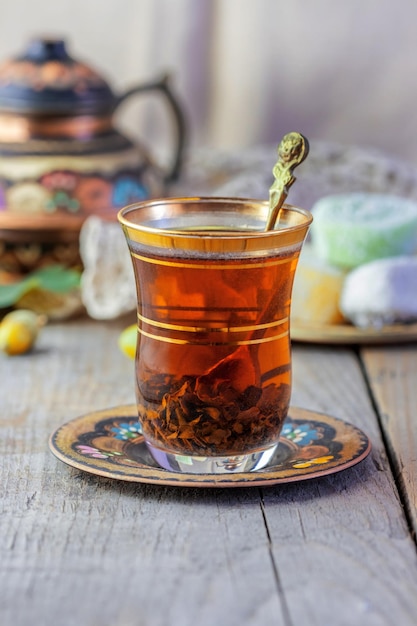 Cup of tea with colorful teapot and turkish delight