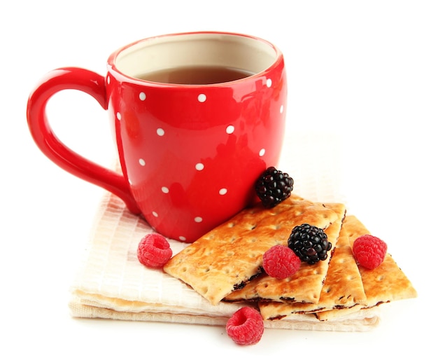 Cup of tea with cookies and berries isolated on white