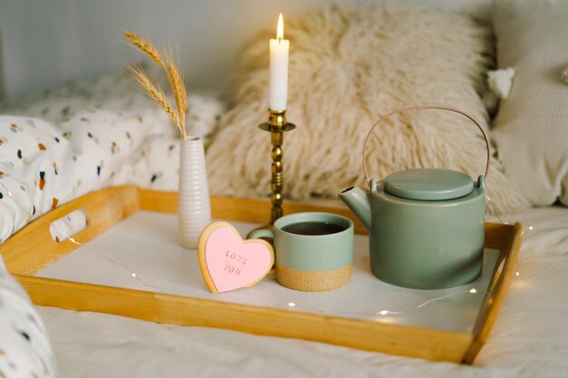 A cup of tea with delicious cookies with the inscription love you Celebrating Valentine's Day at home Concept of Valentine's Day