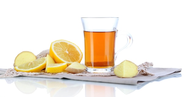 Cup of tea with ginger on napkin isolated on white